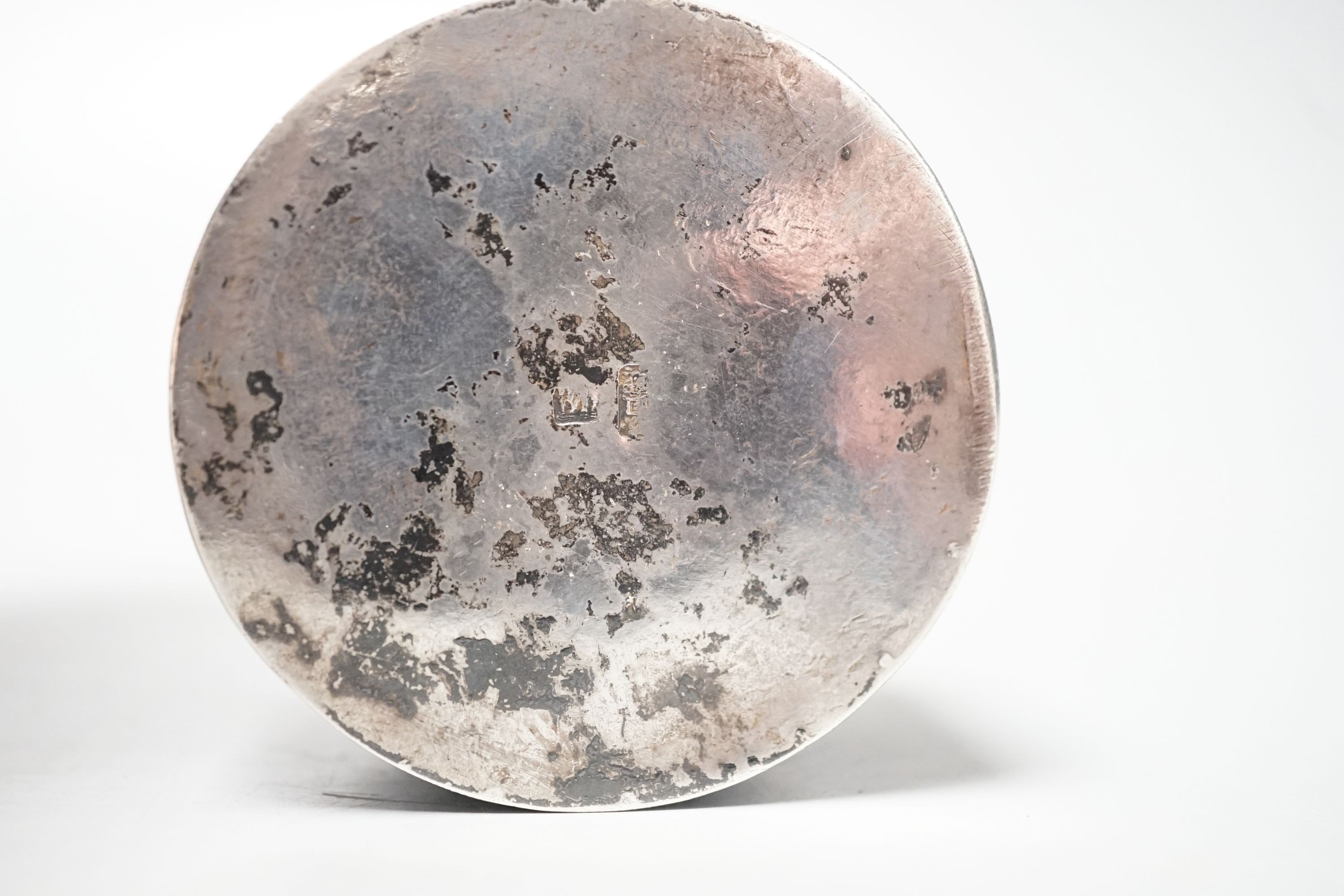 A Chinese embossed white metal circular box and cover, late 19th century, diameter 61mm.
